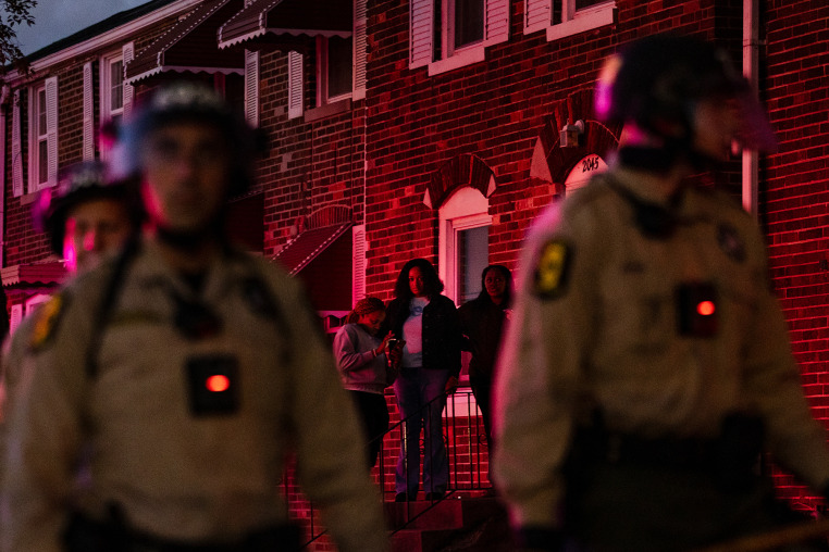 Illinois State police with crowd control gear stand guard outside of homes across from the Broadview ICE facility in Broadview, IL on Saturday, October 11, 2025 