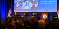 Rev. Michael J.K. Fuller, Archbishop Timothy Broglio and Archbishop William Lori of Baltimore conduct the United States Conference of Catholic Bishops plenary assembly in Baltimore, Md. on Tuesday.
