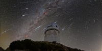 Meteors from the Geminid meteor shower streak across the sky