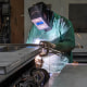 A worker uses an arc welder at the Metal Manufacturing Co. facility in Sacramento, Calif., on May 27, 2025. 