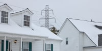 A power transmission line behind homes in a residential neighborhood in Columbus, Ohio, on Tuesday, Dec. 16. 