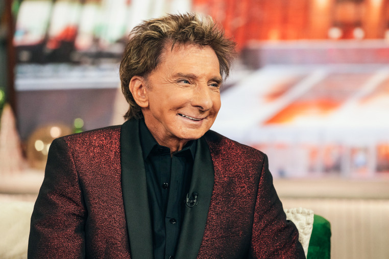 Barry Manilow smiles while seated
