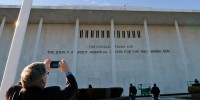 A man photographs the updated lettering outside the Kennedy Center after "Donald J. Trump" was added on Dec. 19, 2025.